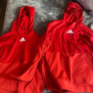 Two matching red Adidas hoodies